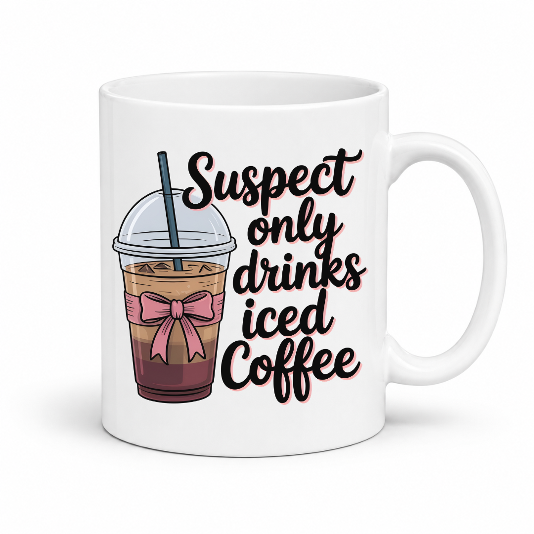 A white ceramic coffee mug with a handle, featuring a printed graphic of an iced coffee cup with a pink bow and the text 'Suspect only drinks iced Coffee' in black script with a pink outline. From Coffee and Moo NZ.