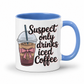A white ceramic mug with a blue handle and interior, featuring a printed graphic of an iced coffee cup with a pink bow and the text 'Suspect only drinks iced Coffee' in black script. From Coffee and Moo NZ.