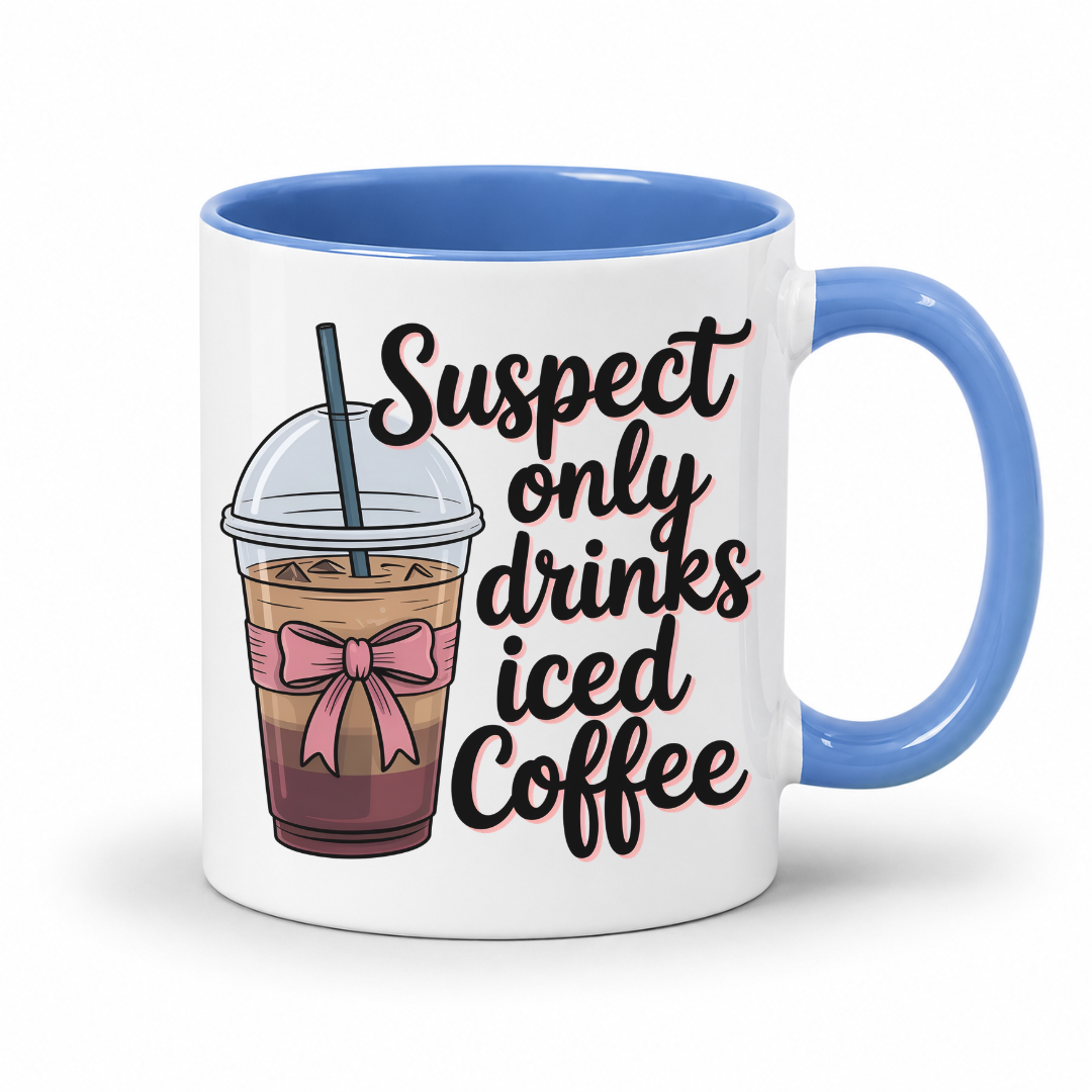 A white ceramic mug with a blue handle and interior, featuring a printed graphic of an iced coffee cup with a pink bow and the text 'Suspect only drinks iced Coffee' in black script. From Coffee and Moo NZ.