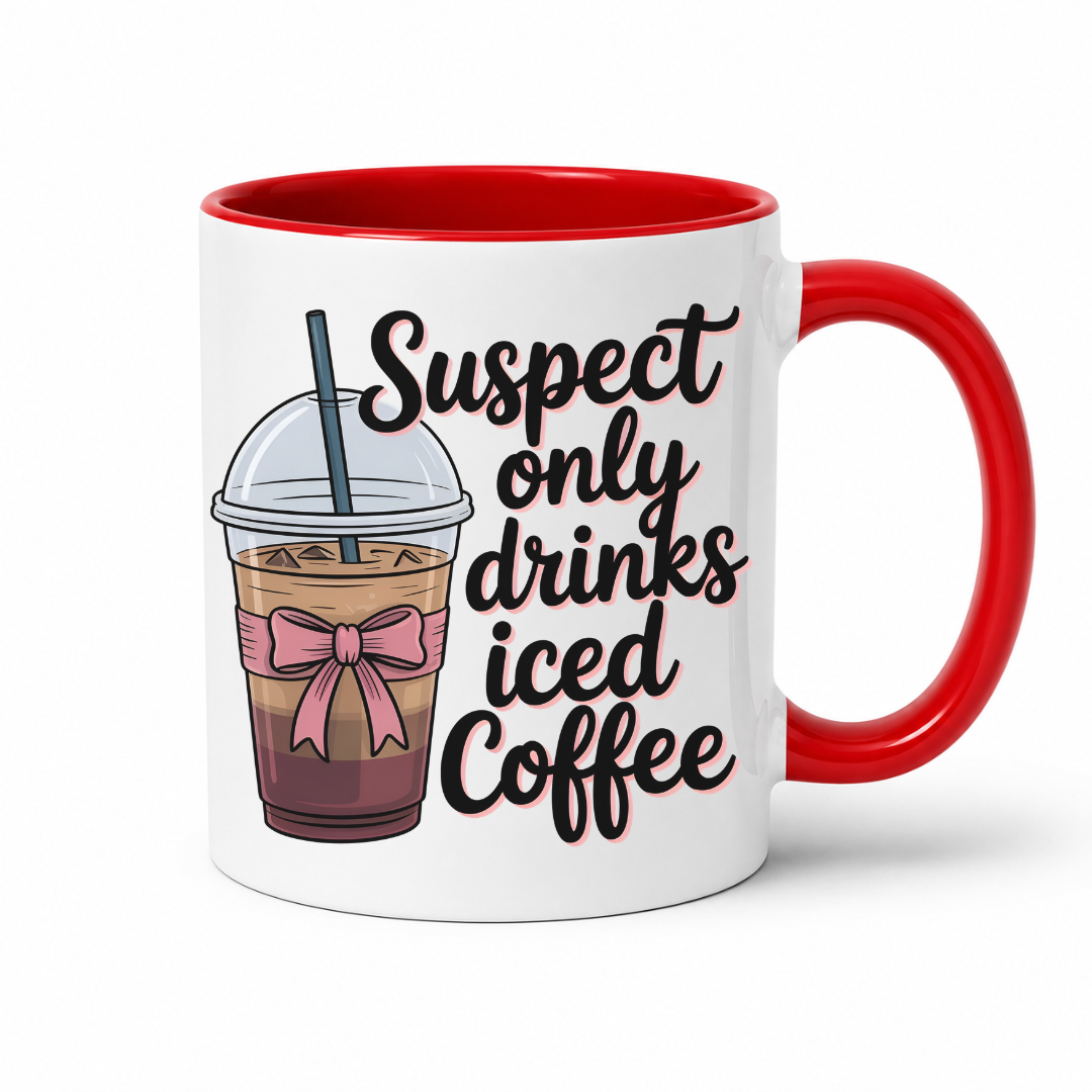 A white ceramic coffee mug with a red handle and red interior, featuring a graphic of an iced coffee cup with a pink bow and the text 'Suspect only drinks iced Coffee' in black script. From Coffee and Moo NZ.