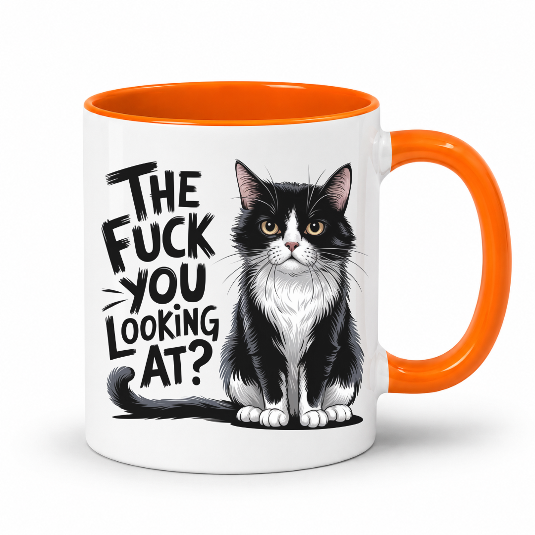 A white ceramic coffee mug with a bright orange handle and interior, featuring a black and white tuxedo cat illustration and the text 'THE FUCK YOU LOOKING AT?' in black stylized lettering.