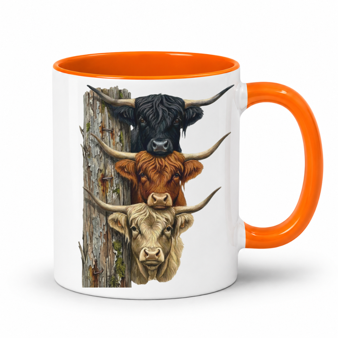 A white ceramic mug with a bright orange handle and interior, featuring a printed graphic of three Highland cows stacked vertically next to a weathered post.  From Coffee and Moo NZ