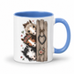 A white ceramic mug with a blue interior and handle, decorated with an illustration of three horse heads next to a rustic wooden post with a heart-shaped bow and flowers. From Coffee and Moo