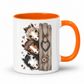 A white ceramic mug with a bright orange handle and interior, featuring a printed illustration of three horse heads beside a rustic wooden post with a heart-shaped ornament. From Coffee and Moo