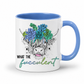 A white ceramic mug with a blue interior and blue handle, featuring a graphic of a highland cow with a colorful succulent flower crown and the text 'WHAT THE fucculent' on a white background. from Coffee and Moo NZ.