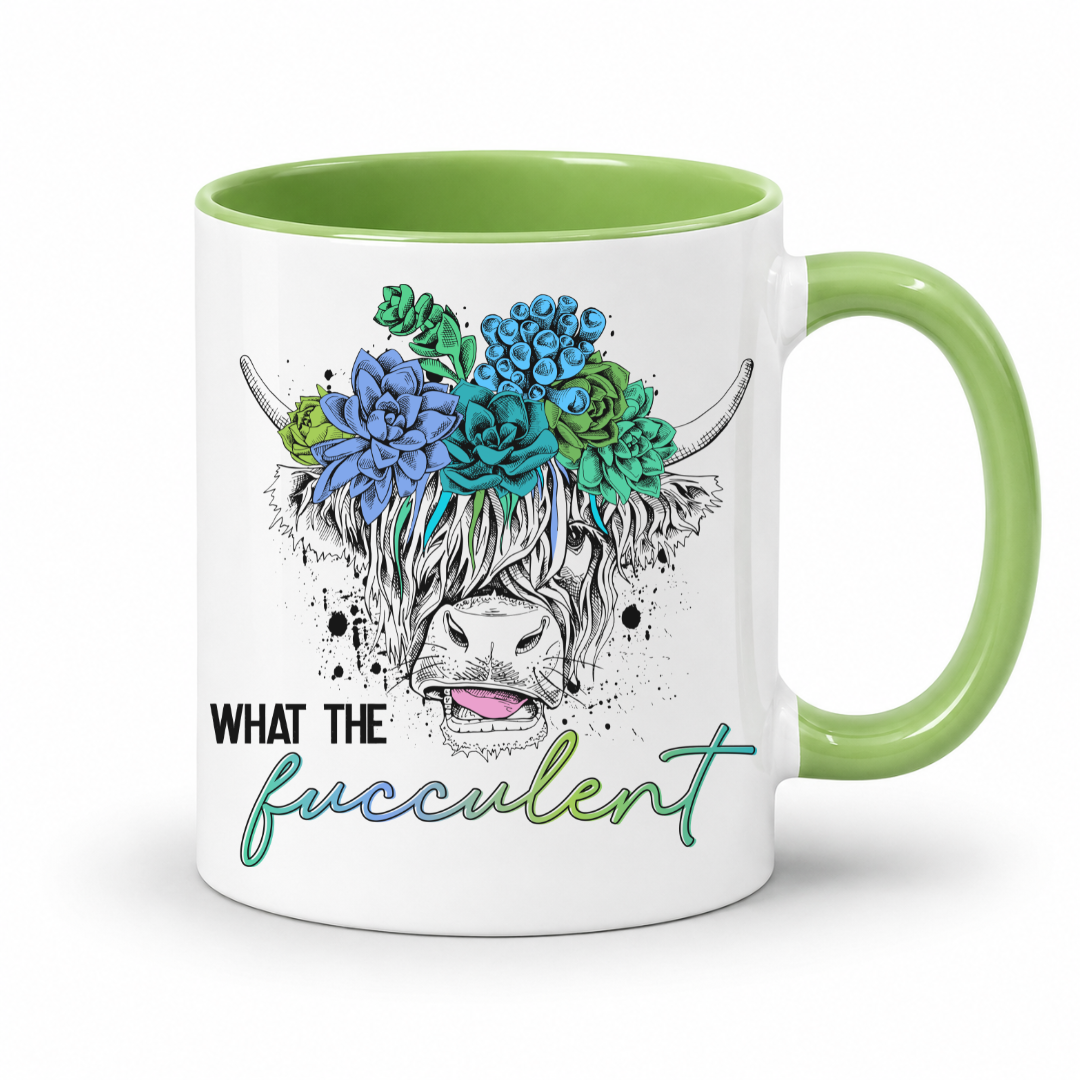 A white ceramic coffee mug with a light green interior and handle, featuring a graphic of a Highland cow's face decorated with blue and green succulents and the text 'WHAT THE fucculent'. from Coffee and Moo NZ.