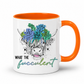 A white ceramic coffee mug with a bright orange handle and interior, featuring a graphic of a highland cow's face decorated with blue and green succulents, and the text 'WHAT THE fucculent' printed below. from Coffee and Moo NZ.
