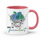 A white ceramic mug with a pink interior and handle, featuring a graphic of a highland cow with blue and green succulents in its horns and the text 'WHAT THE fucculent' printed below. from Coffee and Moo NZ.